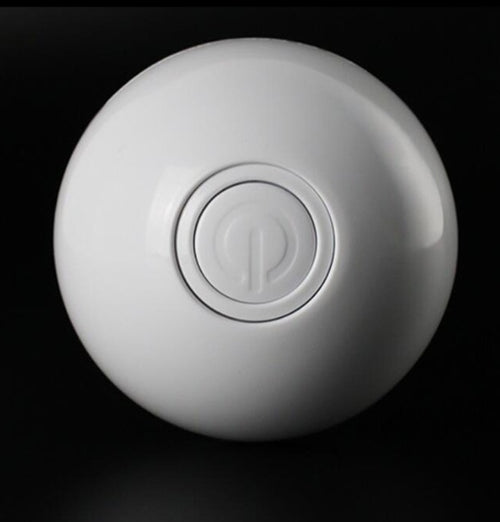 White spherical object with a central logo 