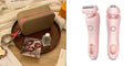 Pink electric shaver with interchangeable heads, beige travel case, and beauty accessories